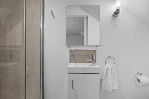 a white bathroom with a sink and a shower at Gloster Town House gorgeous family home Barnstaple in Barnstaple