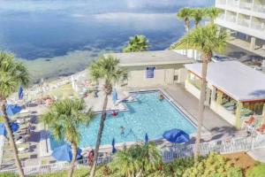 an image of a pool at a resort with palm trees at Cool Notes - Enjoy the sounds of the Bay in Tampa