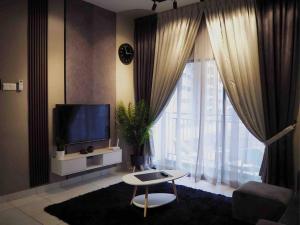 a living room with a tv and a large window at Youth City Cozy Pool View Homestay Nilai by TR in Nilai