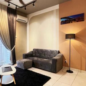a living room with a couch and a lamp at Youth City Cozy Pool View Homestay Nilai by TR in Nilai