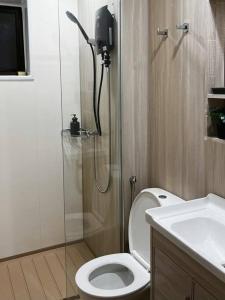 a bathroom with a shower and a toilet and a sink at Youth City Cozy Pool View Homestay Nilai by TR in Nilai