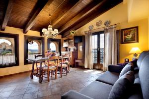 a living room with a table and a dining room at Apartamentos Teresana in Alquézar