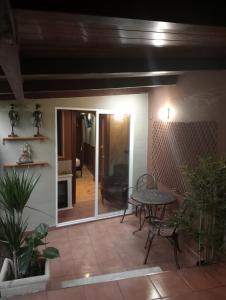 a patio with a table and a table and chairs at Hostal Medievo in Monforte de Lemos