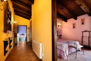 a hallway with yellow walls and a bed in a room at Apartamentos Teresana in Alquézar