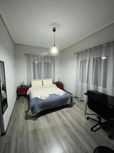 a bedroom with a bed and a desk and a piano at Billy's cozy place Trikala in Tríkala