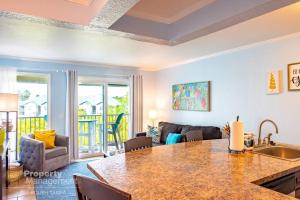 a kitchen and living room with a table and a couch at Tropical Serenity-Water View Heated Pool Tiki Bar in Tampa