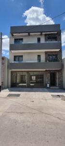 a large building with a lot of windows at Departamento en Mendoza - Le Chat Noir in Godoy Cruz