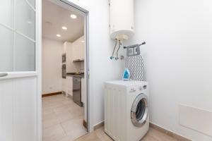 a white laundry room with a washer and dryer at Villa Atlántica - Heated pool in Playa Blanca in Playa Blanca