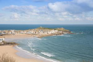 a view of a beach with houses and the ocean at Scots Craig in St Ives