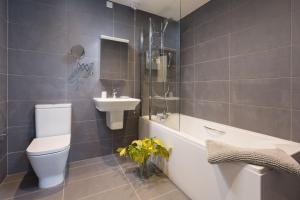 a bathroom with a toilet and a sink and a tub at Scots Craig in St Ives +16 photos