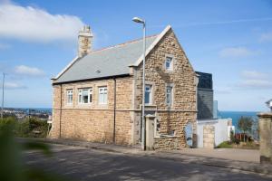 a brick house on the side of a street at Scots Craig in St Ives