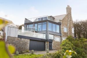 a large brick house with a glass roof at Scots Craig in St Ives