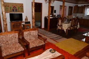 Graviá的住宿－Σοφίτα，客厅配有椅子、桌子和电视