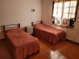 a room with two beds and a window in it at Alojamiento marluz in Trelew