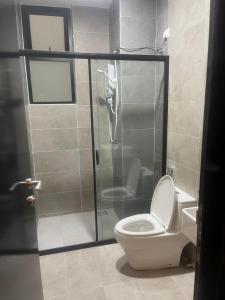 a bathroom with a toilet and a glass shower stall at IPOH TAMBUN THE COVE Your Ultimate Relaxation Getaway777 in Ipoh