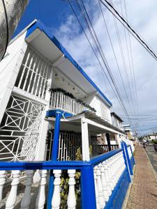 a blue and white building with a balcony at Miss Yasmin Place in San Andrés