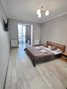 a large bedroom with two beds and a television at Atlant apartments in Chernivtsi