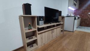 a living room with a entertainment center with a flat screen tv at Vikendica Vrtača- Odvraćenica in Novi Pazar +17 photos
