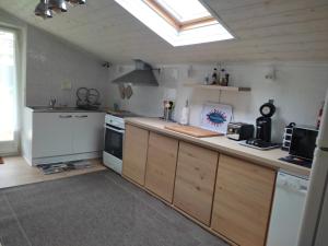 a large kitchen with a skylight in the ceiling at Gîte Domangé-Audenge in Audenge +7 photos
