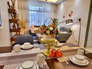 a dining room table with a cake on a table at Sunway Cozy Apartment near Lost World of Tambun in Ipoh