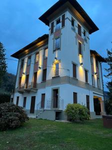 a large white building with lights on it at Villa Jejia in Lesa