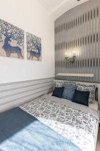 a bedroom with a bed with blue pillows at Urban Oasis Apartment in Budapest