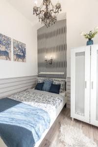 a bedroom with a bed and a chandelier at Urban Oasis Apartment in Budapest