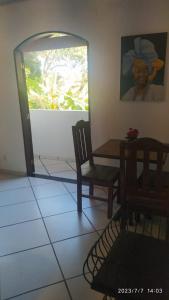 a room with a table and a bench and a painting at Pousada João e Maria in Trindade
