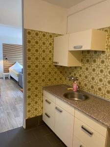 a kitchen with a sink and a counter top at Budgethotel Stadtbett Wolfsburg in Wolfsburg