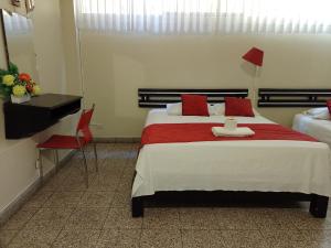 Voodi või voodid majutusasutuse Hotel Resident Piura toas