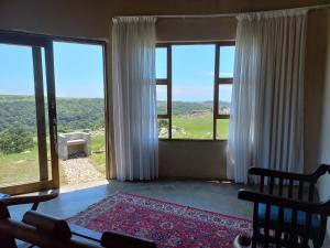a living room with large windows with a view at Kwa Flats-Emaweni in Lusikisiki