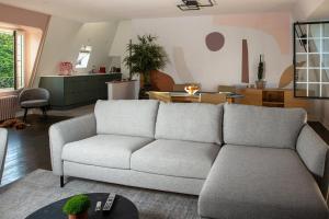 a living room with a couch and a table at La Quinta in Garches