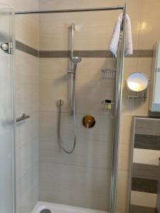 a shower with a glass door in a bathroom at Ferienwohnungen LARA Wohnung 1 in Wallgau