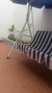 a striped chair sitting on a tile floor at Casa Amplia Completa Privada para Familias in Santa Marta
