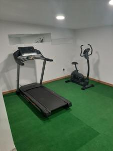 a room with two exercise bikes and a treadmill at A casa di maria in Figari