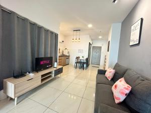 a living room with a couch and a tv at ITCC Manhattan Suites by LAVISH in Kota Kinabalu