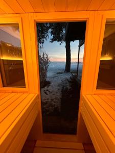 a window of a house with a view of the ocean at Chalet am Feldrand in Starzach