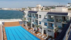 a view of a hotel with a swimming pool at Hotel Port Sitges in Sitges