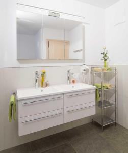 a bathroom with a white sink and a mirror at Appartement Gertraud in Westendorf
