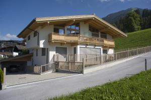 a house with a balcony on the side of a road at Appartement Gertraud in Westendorf