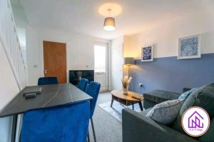 a living room with a couch and a table at Havelock Apartments, City Centre Location in Swindon