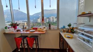a kitchen with a counter with a view of a mountain at B&B Tina in Piano di Sorrento