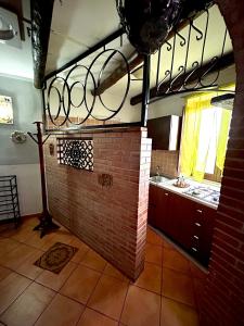 a kitchen with a brick wall and a sink at La casa del Nonno in Altavilla Irpina