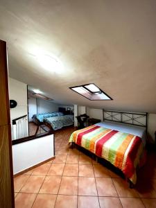 a bedroom with a bed and a skylight at La casa del Nonno in Altavilla Irpina