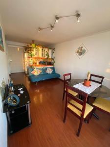 a living room with a table and a dining room at Departamento frente a Playa Brava in Iquique