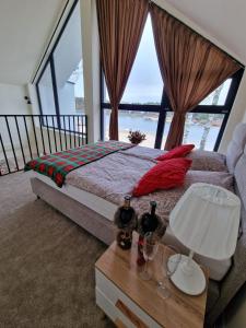 a bedroom with a bed and a table with a lamp at Presto Village in Turawa