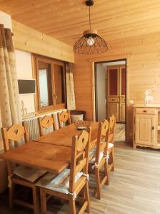 a dining room with a wooden table and chairs at Chalet Mon Idole in Flumet