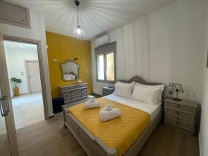 a bedroom with a bed with two towels on it at Aryiro's Residence,Cozy&Sunny in Alikianós