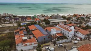 an aerial view of a town next to the ocean at Liiv Cobogó - Natal Ponta Negra in Natal