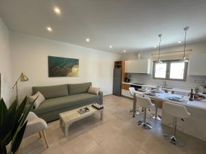 un soggiorno con un divano verde e una cucina di Aryiro's Residence,Cozy&Sunny a Alikianós